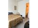 Cozy bedroom with wood floors, a comfortable bed, and an en suite bathroom at 619 Tapatio Ln, Kissimmee, FL 34759