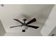 Bedroom ceiling fan with dark blades and neutral ceiling with recessed lights at 619 Tapatio Ln, Kissimmee, FL 34759