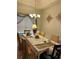 Formal dining room with large table, seating for six, and decorative light fixture at 619 Tapatio Ln, Kissimmee, FL 34759