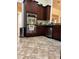 Modern kitchen featuring stainless steel oven appliances and beautiful tiled floors at 619 Tapatio Ln, Kissimmee, FL 34759