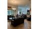 Comfortable living room featuring tiled floors, leather furniture and dining area access at 619 Tapatio Ln, Kissimmee, FL 34759