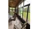 Bright sunroom with sliding windows offering views of the backyard, and a ceiling fan for optimal comfort at 619 Tapatio Ln, Kissimmee, FL 34759
