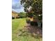 Well-kept yard featuring a large Magnolia tree, landscaped greenery, and manicured lawn at 619 Tapatio Ln, Kissimmee, FL 34759