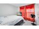 Bedroom with bed, dresser, TV, and red curtains with gold accents near the window at 624 Mercado Ct, Kissimmee, FL 34758