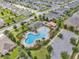 Aerial view of community pool with splash pad, playground, seating and parking at 709 Blackstone St, Minneola, FL 34715