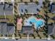 Aerial view of the community pool, playground, and parking areas, surrounded by homes and landscaping at 709 Blackstone St, Minneola, FL 34715