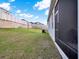 Large backyard with a view of the house and a white fence in the background at 709 Blackstone St, Minneola, FL 34715