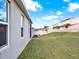 Large backyard with green grass and a white fence in the background at 709 Blackstone St, Minneola, FL 34715