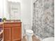 Bathroom features a toilet and sink with a tropical designed shower curtain at 709 Blackstone St, Minneola, FL 34715