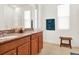 Bright bathroom with double sinks, granite counters, large mirrors, and a glass-enclosed shower at 709 Blackstone St, Minneola, FL 34715