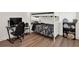 Bedroom featuring a bunk bed, desk with computer, gaming chair, and wood-look floors at 709 Blackstone St, Minneola, FL 34715