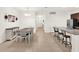 Open floor plan, featuring dining area with long table and the kitchen island breakfast bar at 709 Blackstone St, Minneola, FL 34715