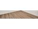 Close up on the new wood-look flooring installed, with white baseboards at 709 Blackstone St, Minneola, FL 34715