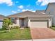 Charming single-story home with a two-car garage and well-manicured lawn at 709 Blackstone St, Minneola, FL 34715