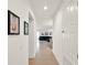 Hallway view leading to the open-concept living space, accented with neutral tile flooring at 709 Blackstone St, Minneola, FL 34715