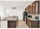 Kitchen featuring stainless steel appliances, granite countertops, tile backsplash, and bar seating at 709 Blackstone St, Minneola, FL 34715