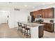 Kitchen features stone countertops, wood cabinets, stainless steel appliances, and breakfast bar seating at 709 Blackstone St, Minneola, FL 34715