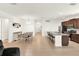 Bright open-concept living space with a kitchen island, dining area, and cozy living room setup at 709 Blackstone St, Minneola, FL 34715