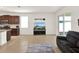 Open-concept living space with tile flooring connecting the living room, kitchen, and dining area at 709 Blackstone St, Minneola, FL 34715