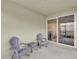 Covered patio with furniture and view of the sliding glass door that leads inside at 709 Blackstone St, Minneola, FL 34715