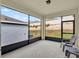 Covered patio with screened windows and furniture and view of the backyard at 709 Blackstone St, Minneola, FL 34715