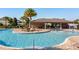 Community pool includes poolside lounge seating, tropical landscaping, and fun interactive water features at 709 Blackstone St, Minneola, FL 34715