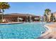 Community pool featuring poolside seating, covered patio, and fun water features for to enjoy at 709 Blackstone St, Minneola, FL 34715