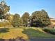 Apartment building surrounded by lush green trees and landscaped grounds on a sunny day at 7240 Westpointe Blvd # 1122, Orlando, FL 32835
