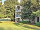 Condo building exterior featuring balconies, lush greenery, and well-maintained lawns at 7240 Westpointe Blvd # 1122, Orlando, FL 32835