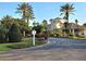 Beautiful clubhouse with manicured landscaping, palm trees, and a roundabout driveway at 7240 Westpointe Blvd # 1122, Orlando, FL 32835