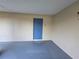 Unit entrance featuring blue door, beige stucco exterior, gray flooring, and exterior light fixture at 7240 Westpointe Blvd # 1122, Orlando, FL 32835