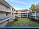 Exterior courtyard view of the condo building with manicured landscaping and balconies at 7240 Westpointe Blvd # 1122, Orlando, FL 32835