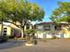Attractive condo building with attached garages, balconies, lush trees, and accessible parking at 7240 Westpointe Blvd # 1122, Orlando, FL 32835