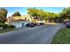 Street view showcasing well-maintained condo building with garages and ample parking at 7240 Westpointe Blvd # 1122, Orlando, FL 32835