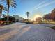 An estate home with a circular driveway, surrounded by palm trees and well-manicured landscaping at 7240 Westpointe Blvd # 1122, Orlando, FL 32835