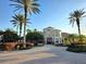 An estate home with a circular driveway, surrounded by palm trees and well-manicured landscaping at 7240 Westpointe Blvd # 1122, Orlando, FL 32835