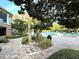 Resort style pool area with lush landscaping, lounge chairs, and shade trees for ultimate relaxation at 7240 Westpointe Blvd # 1122, Orlando, FL 32835