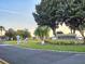 Bermuda Dunes Luxury Condominiums sign with manicured landscaping, palm trees, and golf cart crossing at 7240 Westpointe Blvd # 1122, Orlando, FL 32835