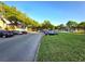 Street view of condo community lined with trees and parked cars at 7240 Westpointe Blvd # 1122, Orlando, FL 32835