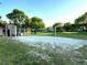 Outdoor sand volleyball court surrounded by green grass and trees at 7240 Westpointe Blvd # 1122, Orlando, FL 32835