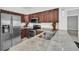 Modern kitchen features stainless steel appliances, granite countertops, and dark wood cabinets at 783 Celebration Ave # 783, Celebration, FL 34747