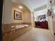 Spacious bathroom boasts a large soaking tub, walk-in shower, and double sink vanity for a spa-like experience at 8125 Resort Village Dr # 5310, Orlando, FL 32821