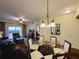View of the combined living and dining area with balcony access, showcasing ample natural light at 8125 Resort Village Dr # 5310, Orlando, FL 32821