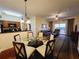 Cozy living area with dining table, sliding door to a private balcony, and adjacent kitchen at 8125 Resort Village Dr # 5310, Orlando, FL 32821