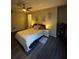 Well-lit bedroom featuring modern ceiling fan, decor and hardwood floors at 911 N Orange Ave # 142, Orlando, FL 32801