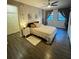 Comfortable bedroom featuring wood floors, ceiling fan, and dual windows at 911 N Orange Ave # 142, Orlando, FL 32801