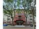Attractive building entrance framed by trees and street lights at 911 N Orange Ave # 142, Orlando, FL 32801