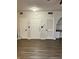 Bright entryway with wood-look floors and multiple white doors creates an inviting and functional space at 911 N Orange Ave # 142, Orlando, FL 32801