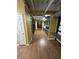 Bright hallway with wood floors, exposed ductwork, and office spaces, creating a unique and modern aesthetic at 911 N Orange Ave # 142, Orlando, FL 32801