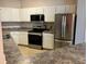 Modern kitchen with stainless steel appliances, white cabinets, and durable countertops at 911 N Orange Ave # 142, Orlando, FL 32801